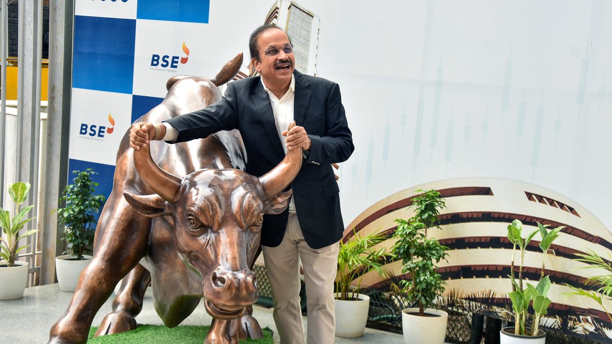 Hero Motors chairman poses with bull statue at BSE listing