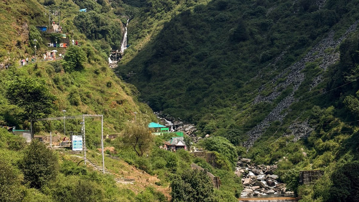 Lush green gorge and stream lead to Bhagsunag Waterfall near McLeod Ganj