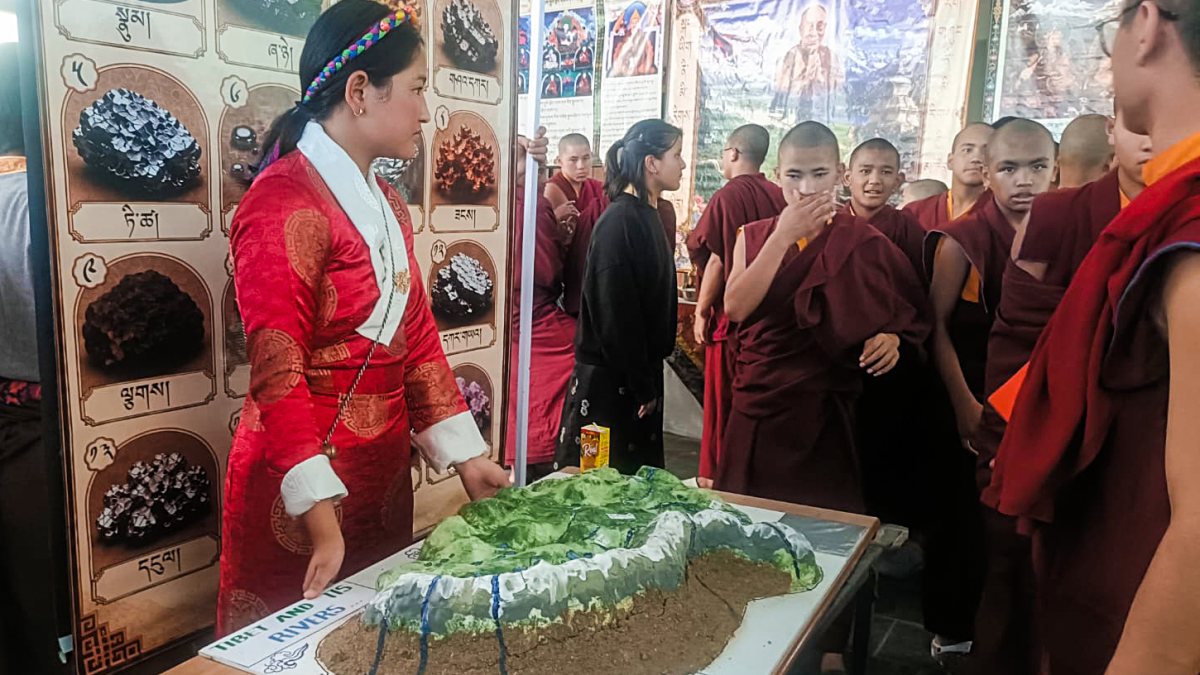 Student explains Tibet rivers model to monks in Shimla