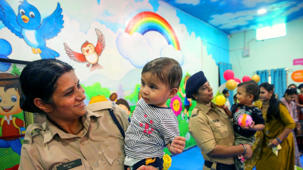 Woman cop with child at creche inauguration in Bhopal