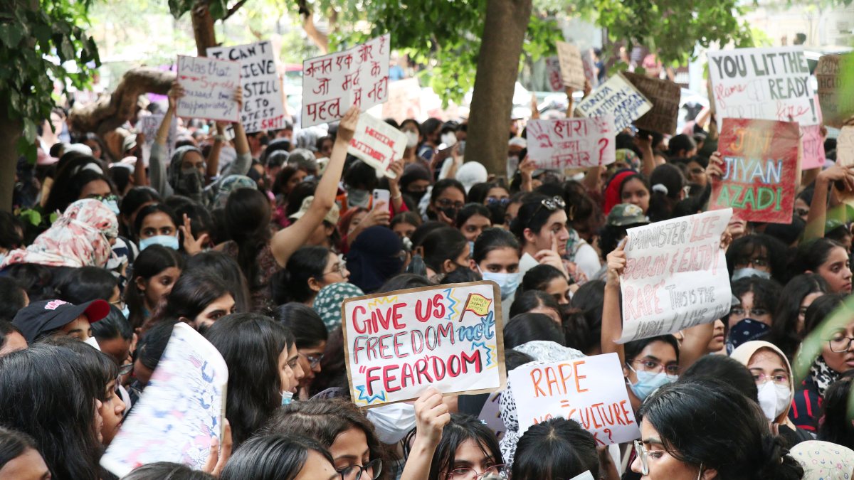 Students protest with placards at Kamala Nehru College in New Delhi