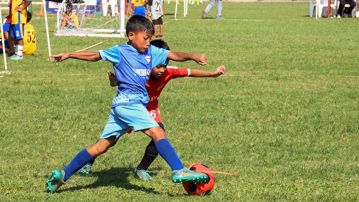 Kids compete for ball at Guwahati football league