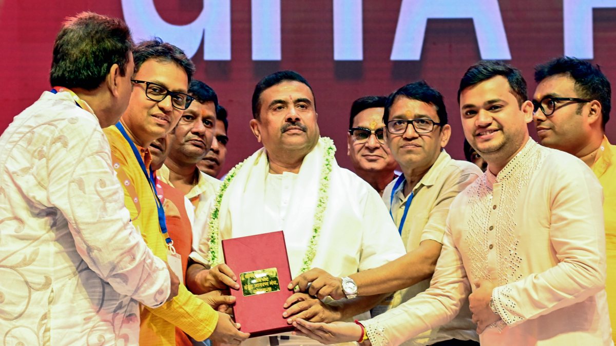 Suvendu Adhikari poses with book at Gita recital in Kolkata