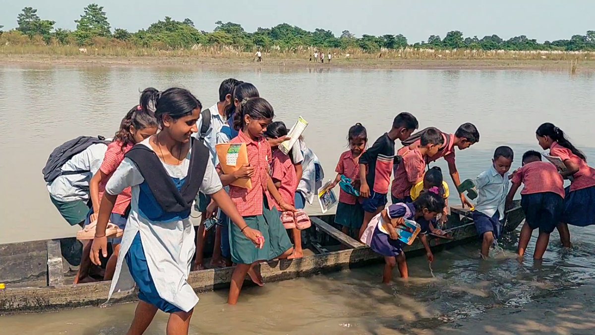 Assam students take boat to school as village lacks bridge