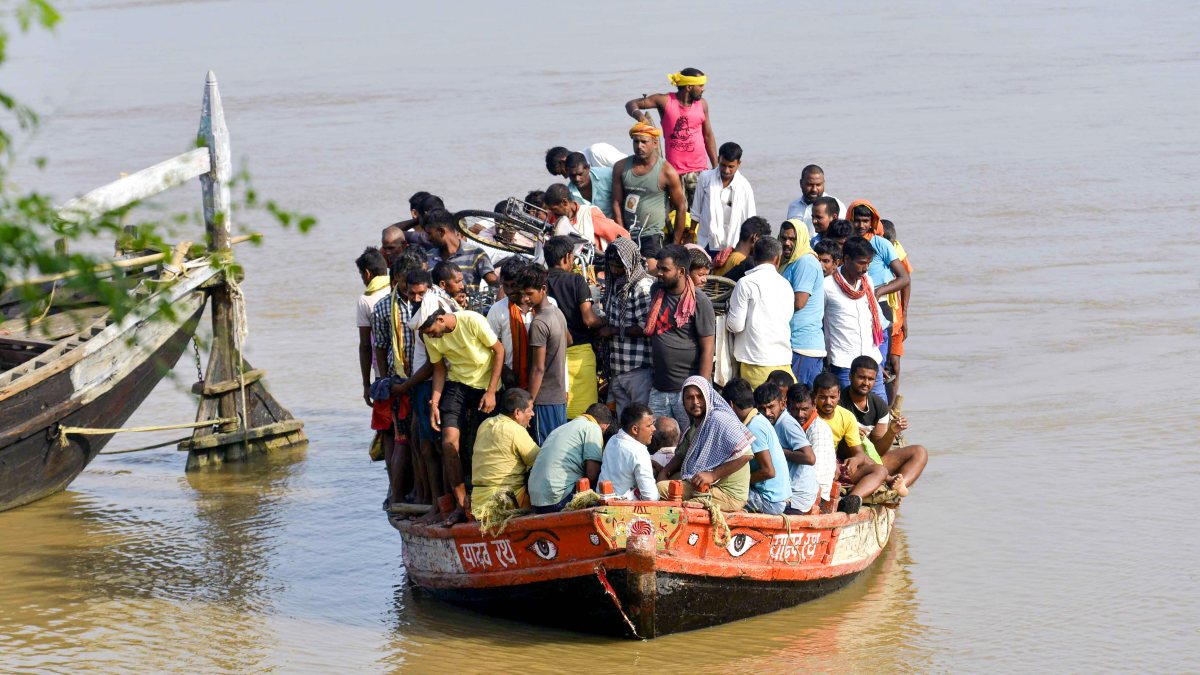 Patna locals ferried by boat through flooded Ganga areas