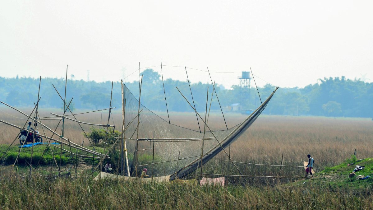 Villagers cast fishing nets on a lake in Nagaon