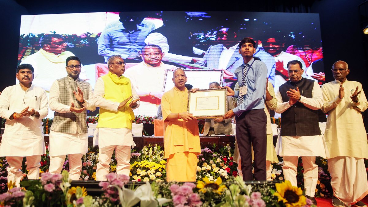 Yogi Adityanath presents scholarship certificate to student in Lucknow