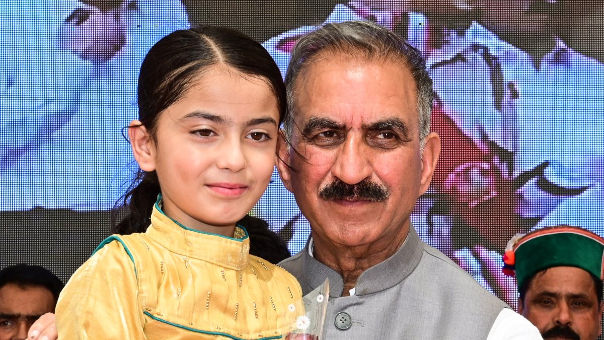 Himachal CM Sukhu poses with child at Shimla public meeting