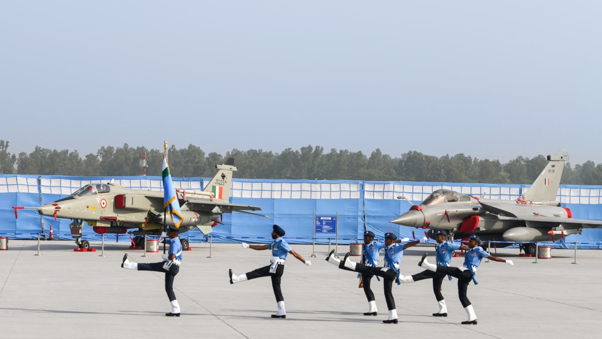 IAF personnel march past Jaguar and Rafale aircraft at Hindon