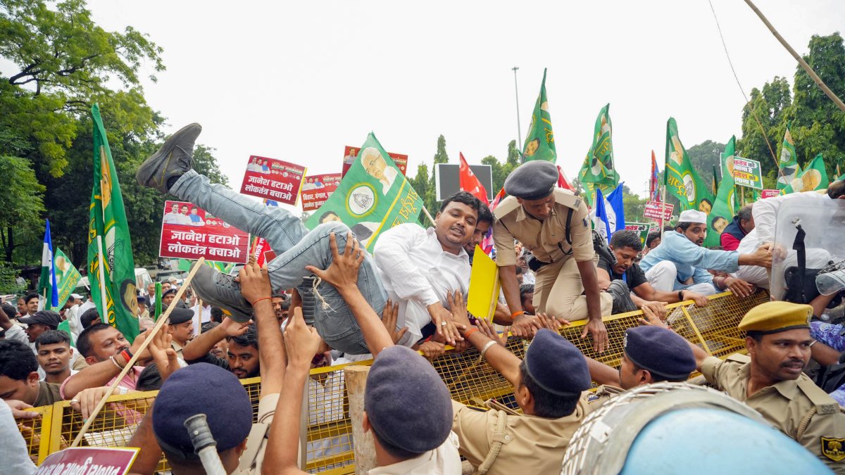 INDIA bloc supporter climbs barricade during Patna protest march