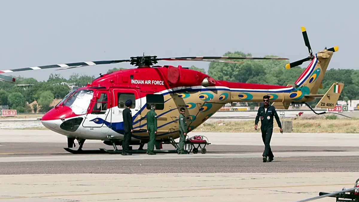 Military officials stand beside HAL Dhruv at Tarang Shakti 2026 in Jodhpur