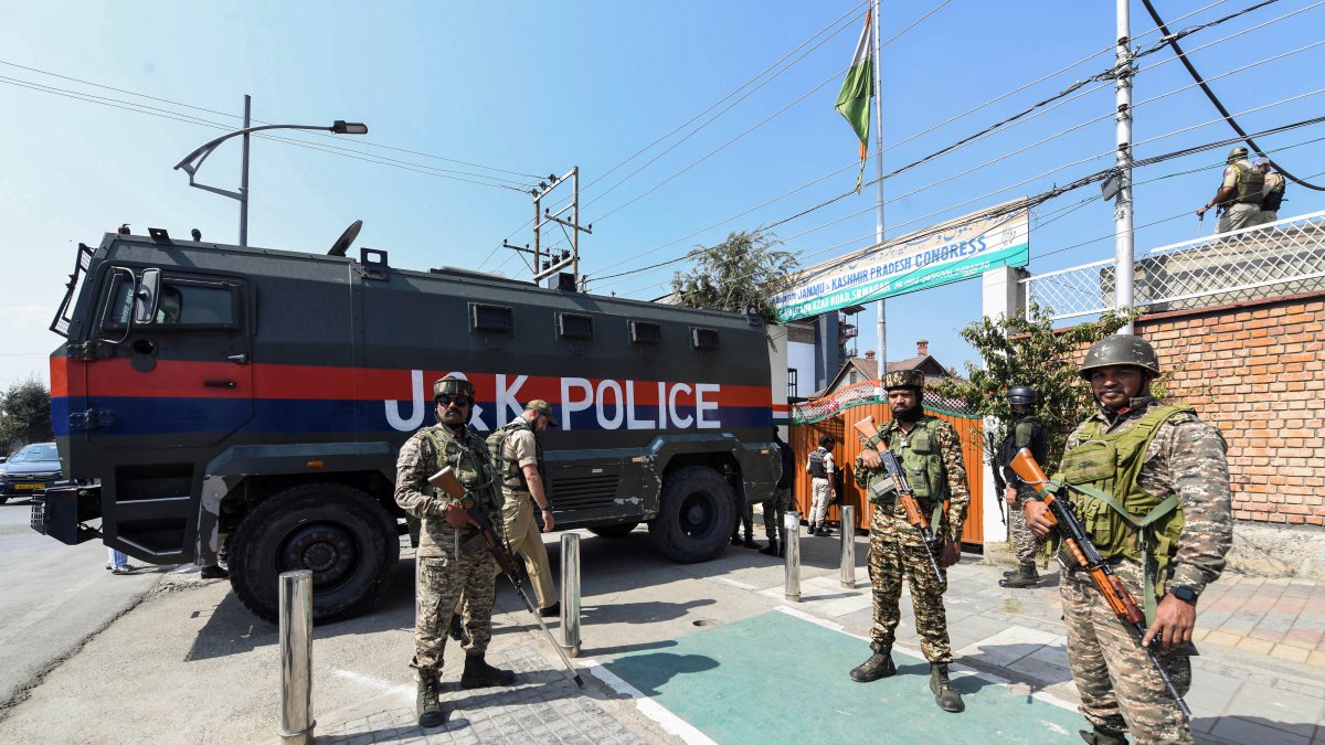Security personnel stand guard during Congress led protest in Srinagar