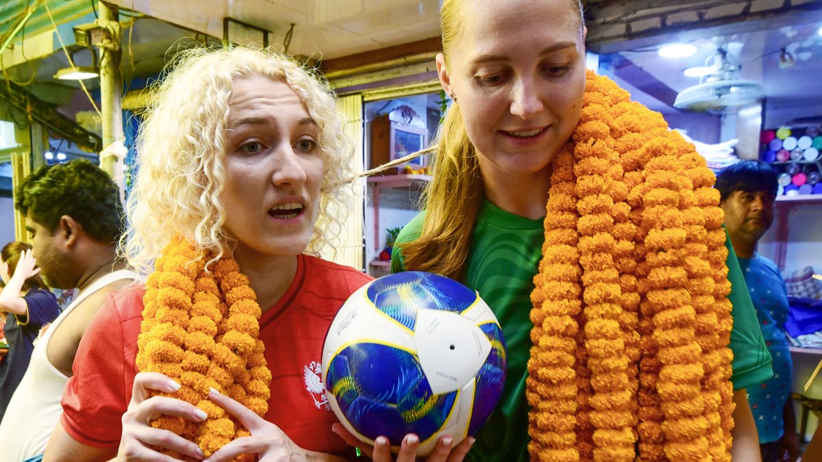 Russian women football team visits Kolkata flower market