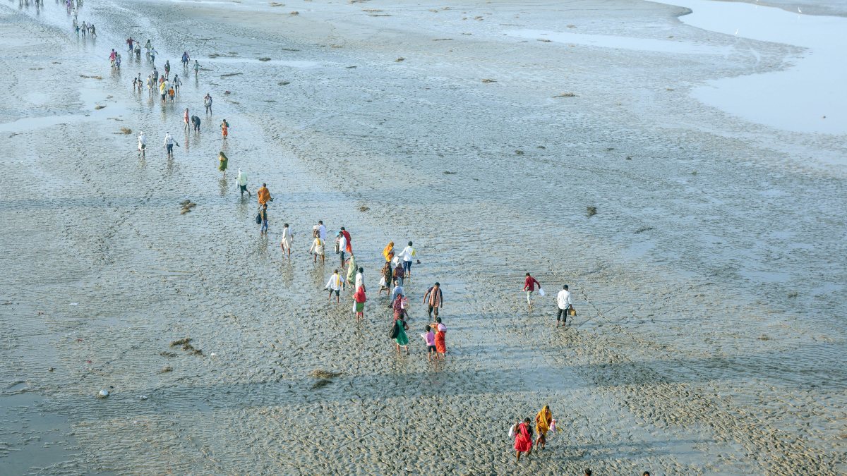 Devotees wade through mud for holy dip in Ganga during Navratri