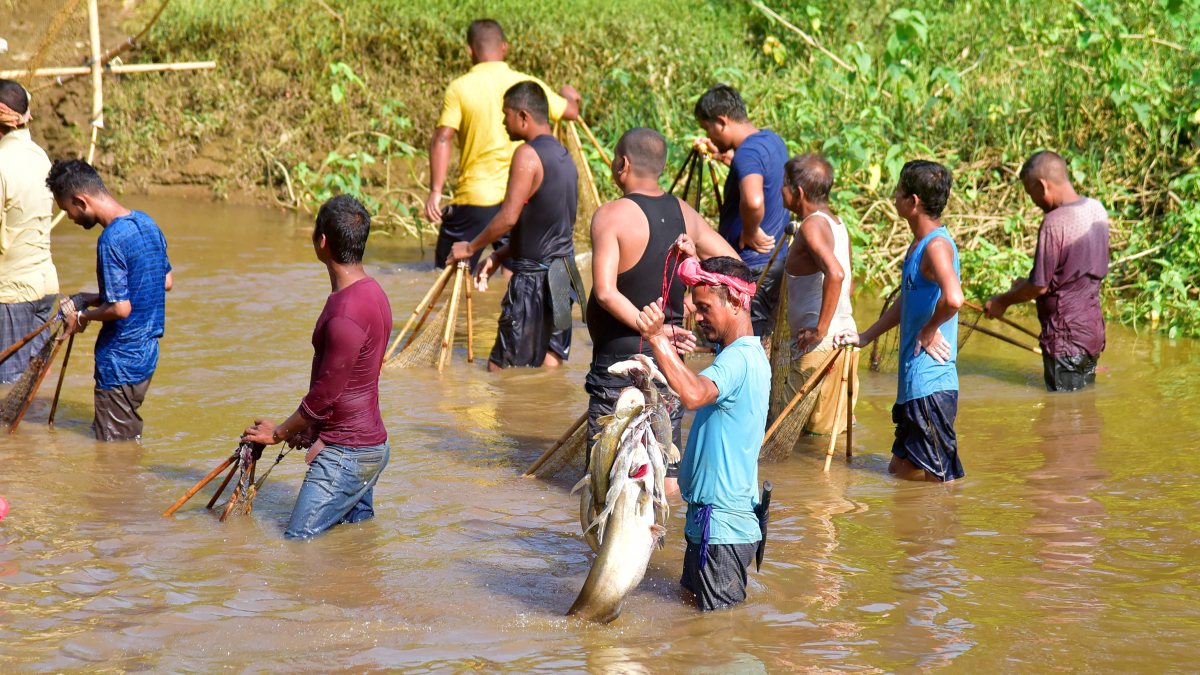 Villagers catch fish in Boko River in Kamrup