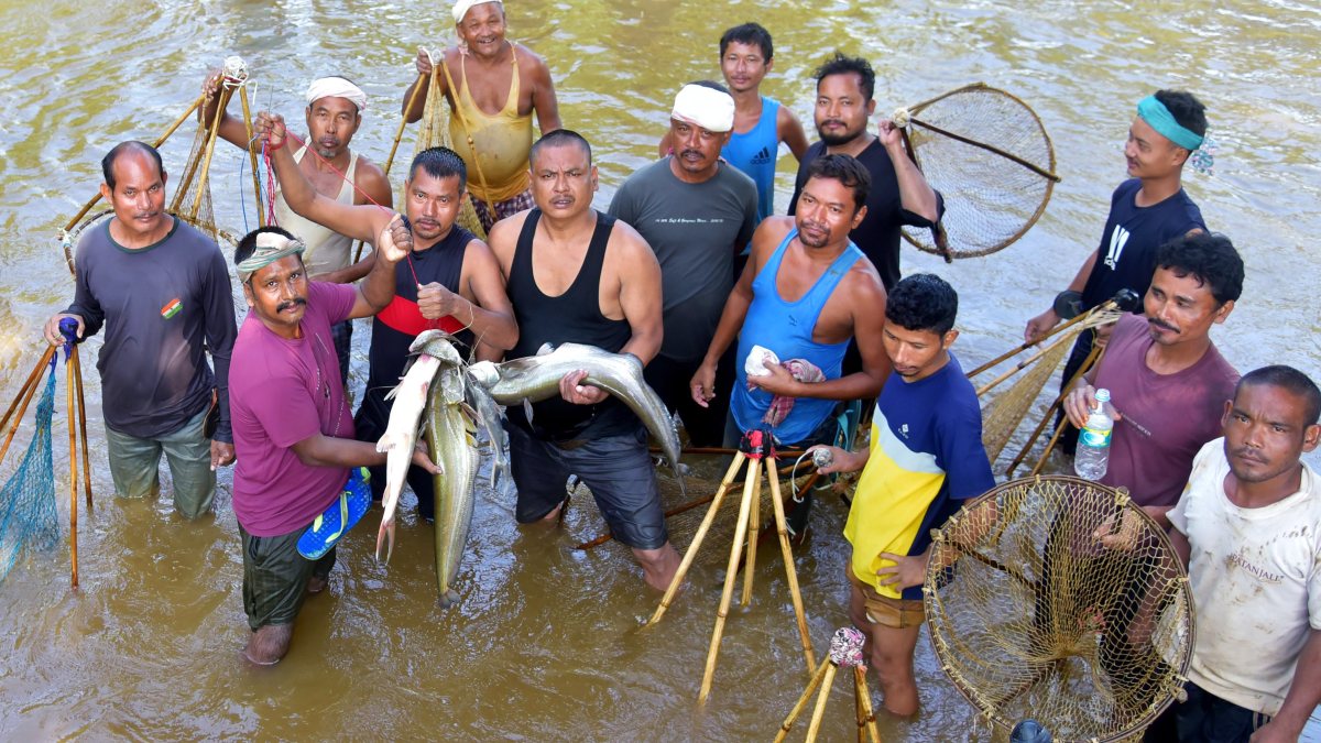 Villagers catch fish in Boko River in Kamrup