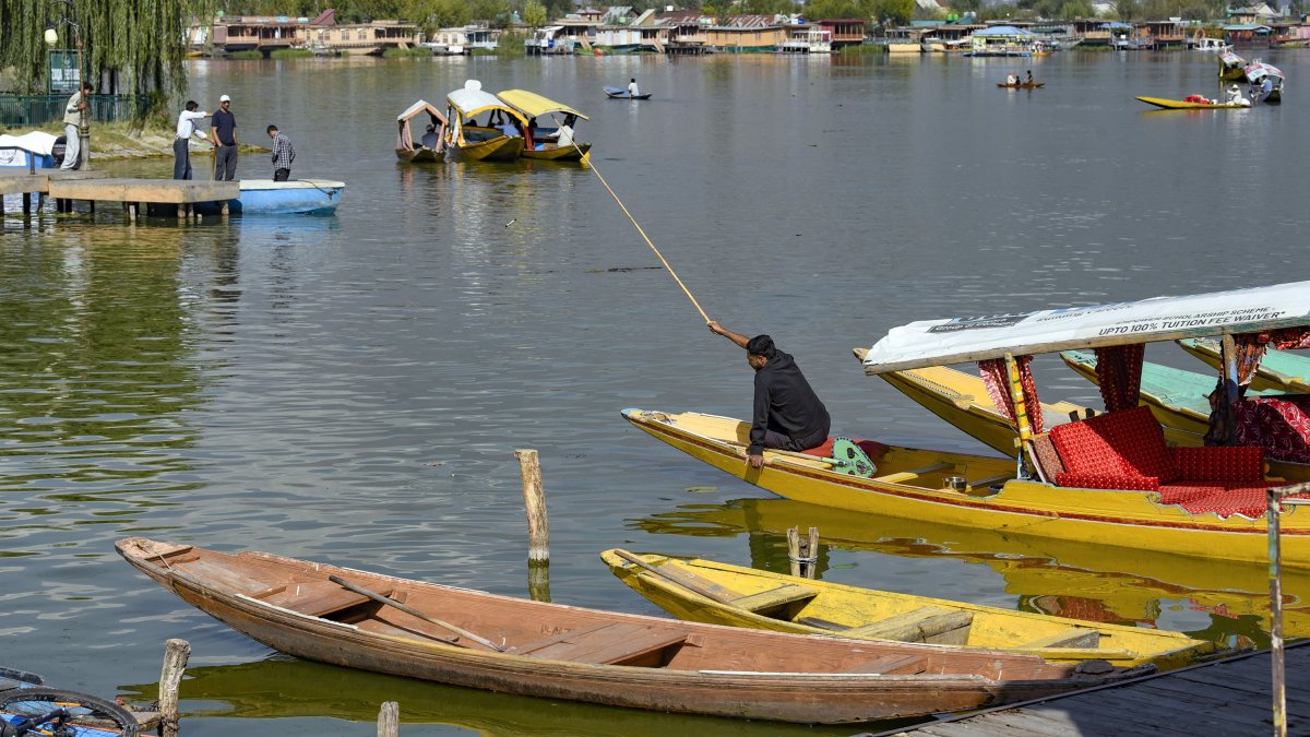 Man catches fish on Shikara at Dal Lake in Srinagar