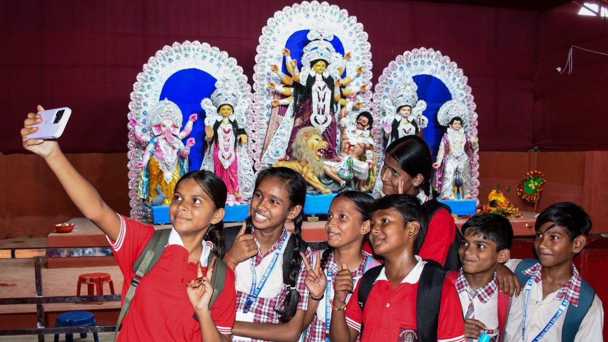 Students take selfie at Durga Puja pandal in Prayagraj
