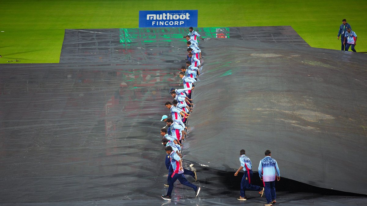 Ground staff remove pitch covers as rain stops before India West Indies T20I in Bengaluru