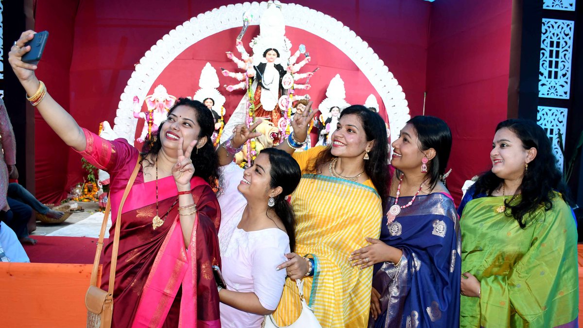Women devotees take selfie at Durga Puja pandal in Prayagraj