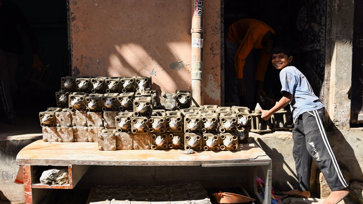 Child arranges clay temples ahead of Diwali in Delhi