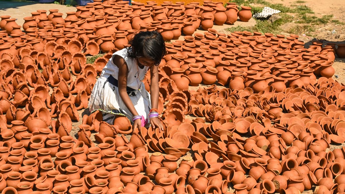 Girl dries painted diyas ahead of Diwali in Ranchi