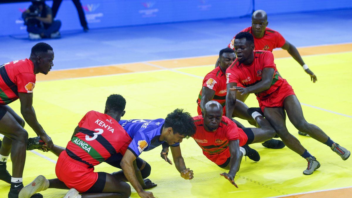 Kenya players catch Singapore raider at kabaddi championship