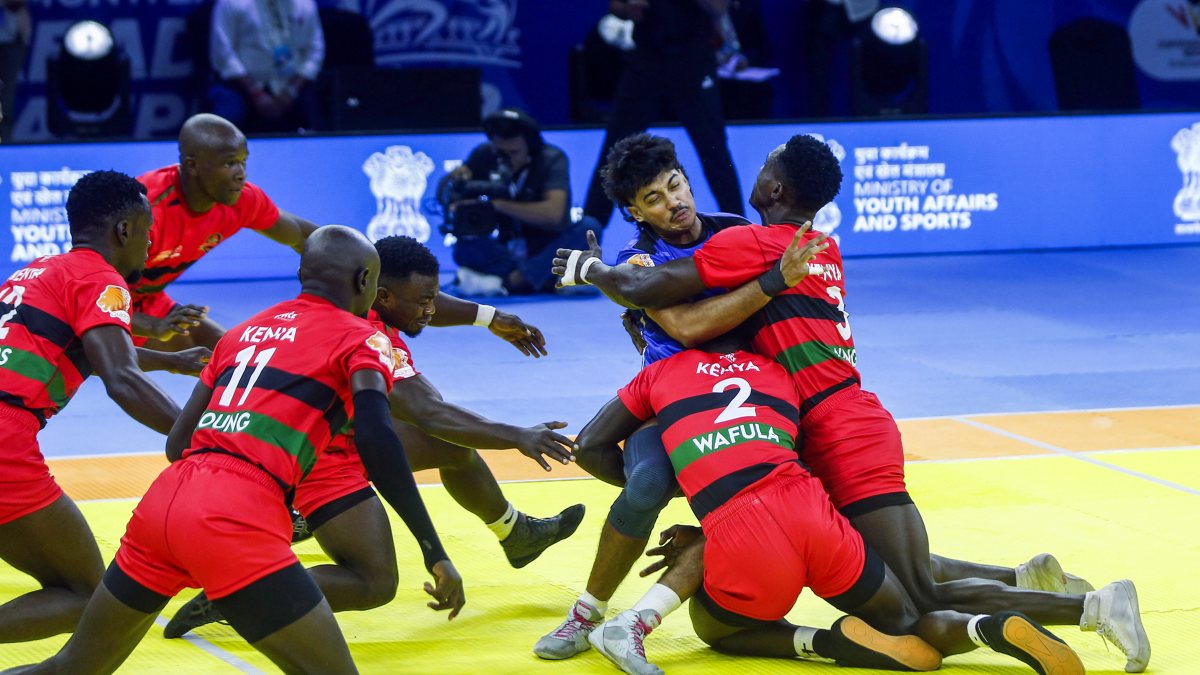 Kenya players tackle Singapore raider at kabaddi championship