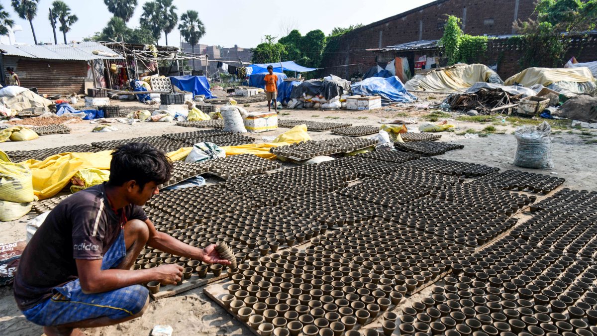 Potter dries earthen lamps in sun ahead of Diwali in Patna
