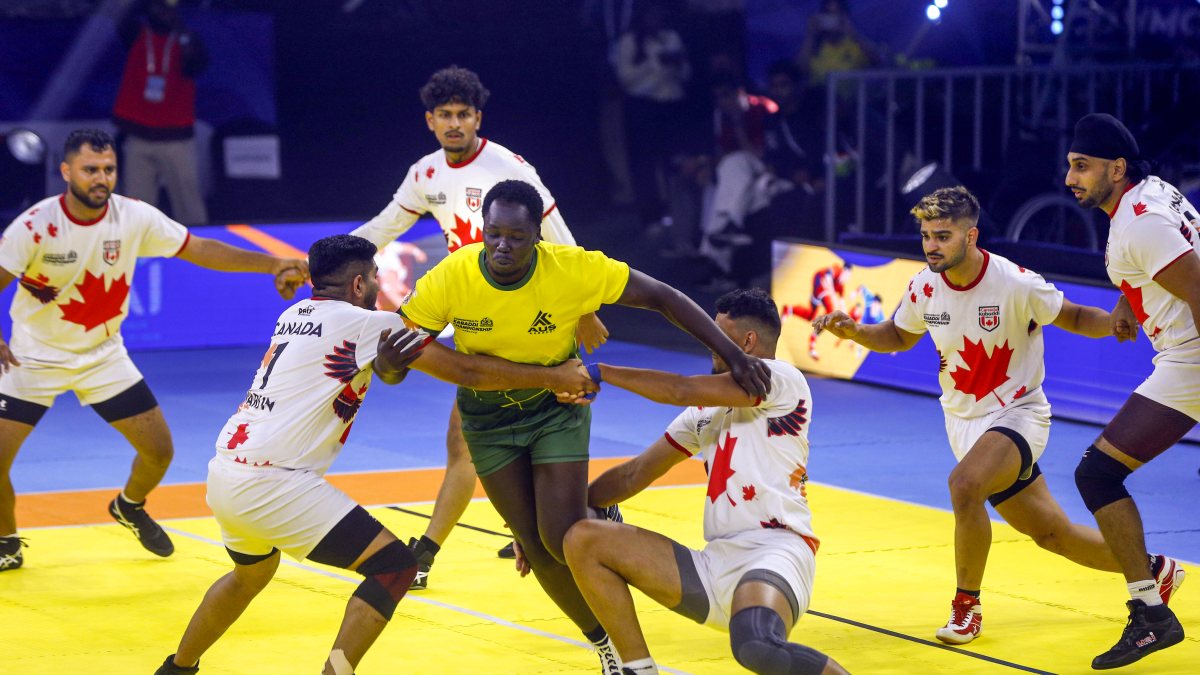 Canada players tackle Australian rider at kabaddi championship