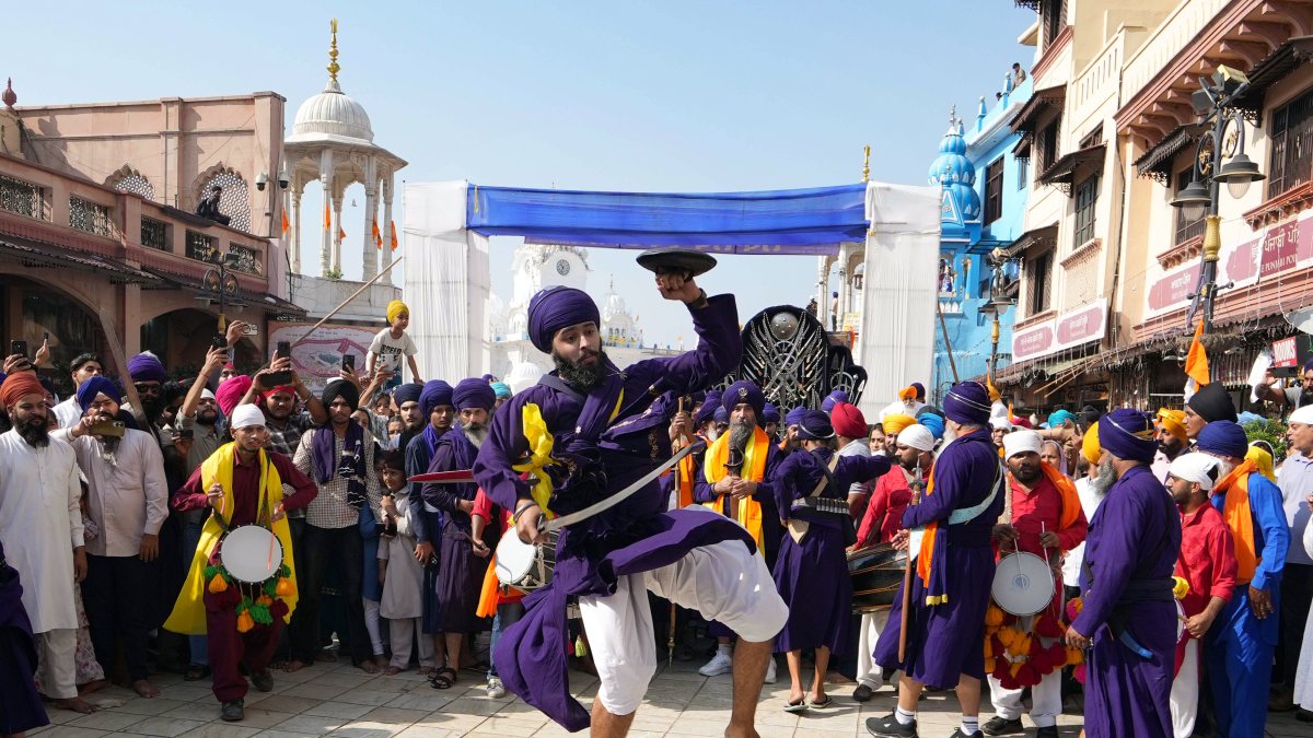 Nihang Sikhs perform Gatka at Golden Temple procession in Amritsar